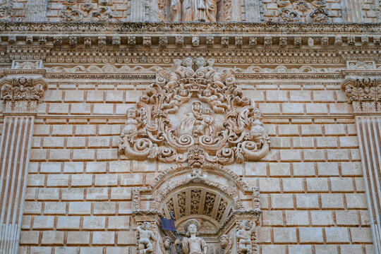 Close up of the Madonna and Child stone carving on the baroque facade of Sassari Cathedral in Sardinia, Italy