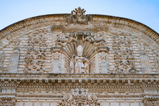 Close up of Saint Nicholas statue and carved pediment on the baroque facade of Sassari Cathedral in Sardinia, Italy