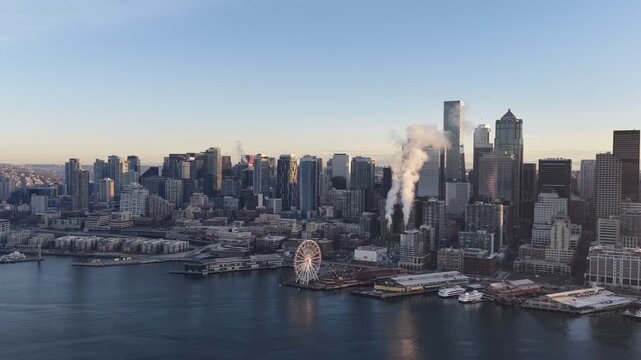 Seattle skyline with Space Needle and waterfront ferris wheel at sunset, urban cityscape, Washington USA. g.