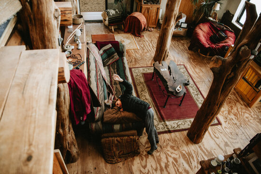 Boy Resting on Couch in Rustic Cottage