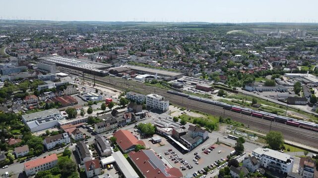 Oblique drone view shows Paderborn station, rail tracks, and surrounding city.