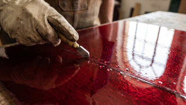 French glass stainer cutting vibrant red antique cathedral glass diamond tip cutter window reflection