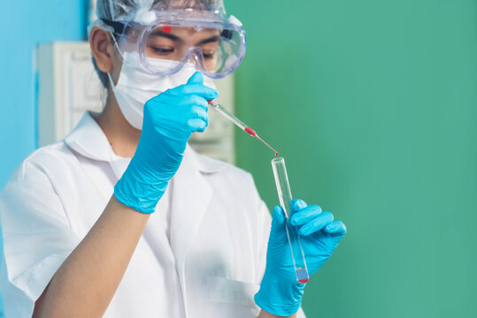 Scientist man holding chemical test glass tube testing science laboratory. Doctor clinic healthcare lab technician diagnosis sample. Asian man scientist working vaccine test medical biochemistry lab