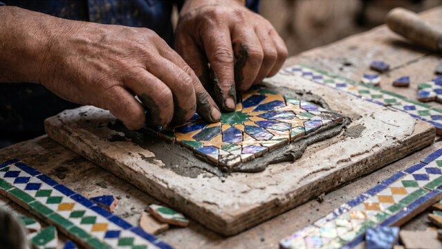Zellij mosaic tiler hand assembling complex tile array face down plaster board gray mortar