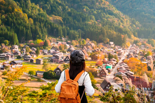 Young female traveler enjoying with colorful foliage at shirakawa-go in autumn, Travel japan concept