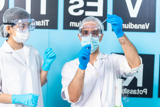Scientist man woman working together team partner look into Microscope research in science laboratory. Two Asian scientist use microbiology microscope chemistry lab equipment. Biochemistry researcher
