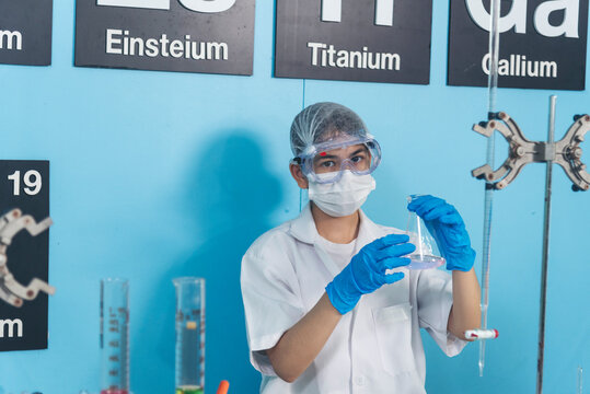 Scientist man holding chemical test glass tube testing science laboratory. Doctor clinic healthcare lab technician diagnosis sample. Asian man scientist working vaccine test medical biochemistry lab