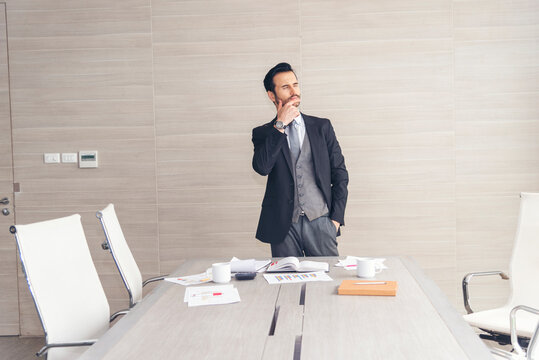 Portrait caucasian man businessman smiling face confident leader manager in meeting rooom office desk. Caucasian handsome man success look away thinking poses. Happy positive Handsome CEO