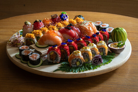 Colorful Sushi Assortment on Display. Diverse Sushi Platter on Wooden Table