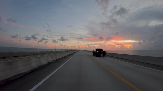Driving Into the Dusk, Highway Over Water at Twilight, drive along a two lane highway built over a body of water as the sun sets, Florida