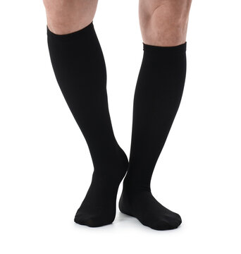 Man wearing black knee-high compression socks