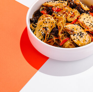 Asian chicken noodles with vegetables and sesame seeds