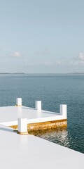 Fototapeta premium Surreal a calm harbor water surface lifting like a folded sheet against a realistic white dock for climate change and storm surge concepts