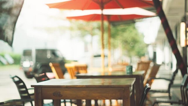 Empty wooden tables at an outdoor cafe with blurred background