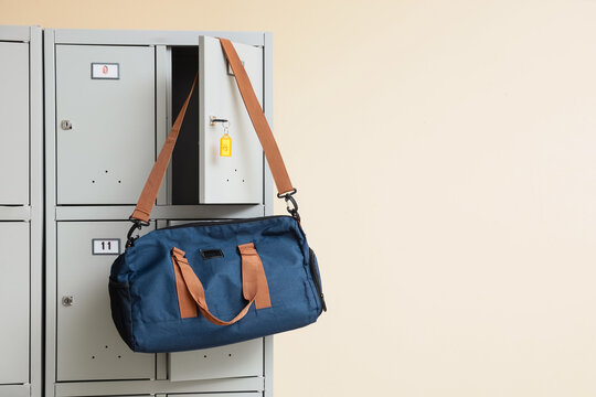 Blue duffel bag hanging from open locker door