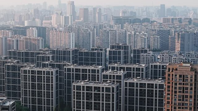 Aerial view of dense apartment buildings in China during daytime pollution, with a tall cityscape