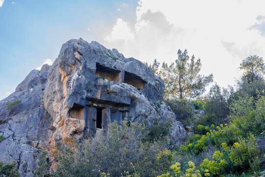 Ancient Lycian rock-cut tomb carved into a mountain cliffside