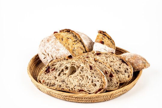 Freshly baked sourdough bread loaf on the basket and white background with full depth of field. Artisanal or healthy food concept