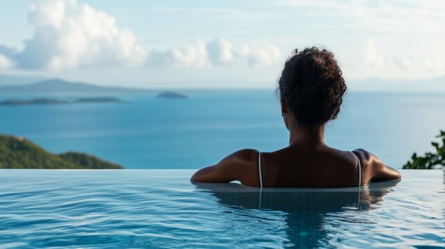 Serene Escape: A woman enjoys a tranquil moment, gazing at the expansive ocean view from the edge of an infinity pool, embodying relaxation and escape.