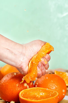Fresh Orange Citrus Fruit Being Peeled with Juice Dripping
