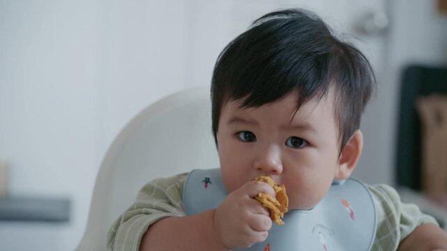 Cute Asian Toddler Eating Finger Food at Home, Healthy Childhood and Family Lifestyle in 4K