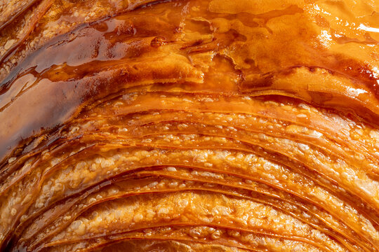 High-Resolution close-up of sweet croissant crust ultra sharp macro and extreme detail of crunchy flaky pastry layer background full frame