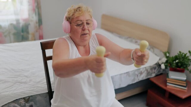 Smiling senior woman finishing her workout giving thumbs up at home fitness at home