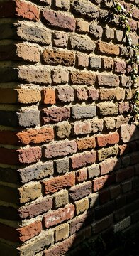 Close-Up of Old Brick Wall Showing Texture and Color Variations.