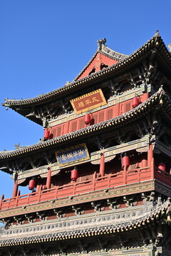 The majestic Taiping Tower rises gracefully in Datong's ancient city, its Ming-style architecture blending history with meticulous reconstruction under golden sunlight.