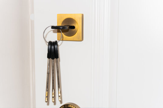 A man's hand opens a door lock with a key, door lock repair, handyman or lock picking, protection from thieves with a handy key and lock. High quality