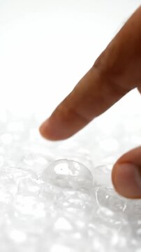 Finger pressing and popping bubble wrap plastic for stress relief and satisfying texture