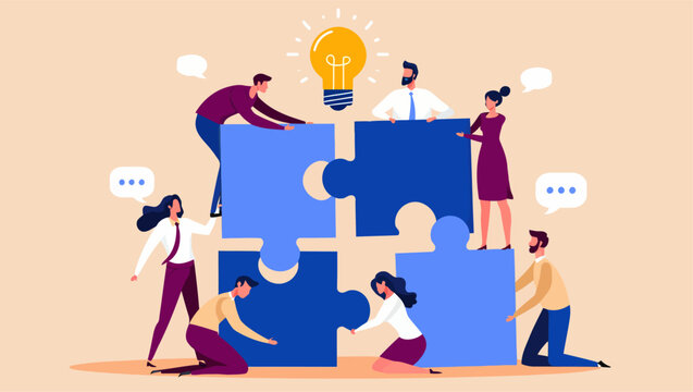 Professional business team working together to assemble large blue jigsaw puzzle pieces under a glowing yellow lightbulb representing a creative spark of innovation and strategy