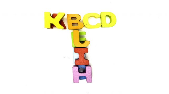 The alphabet makes the letter T with colored wooden letters 