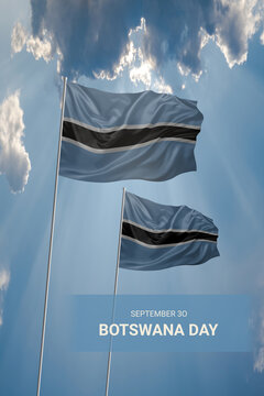Two flags of Botswana in blue sky with clouds for National holiday