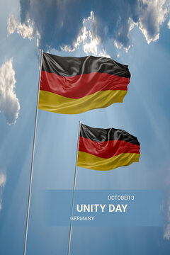 Two flags of Germany in blue sky with clouds for National holiday