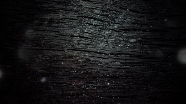 Dark wood grain gleams softly under dim light. Faint bokeh highlights add depth and mystery. Natural textures evoke aged, rustic elegance. Ideal for backgrounds in moody or vintage design