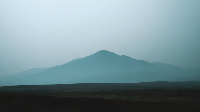 Misty mountain landscape with foggy sky