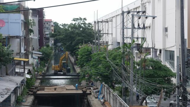 Excavator Dredging Urban Canal Bangkok Construction Public Infrastructure Maintenance Waterway Cleaning City Buildings Backdrop Footage Aerial View
