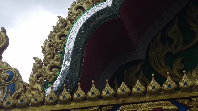 Ornate Thai Temple Roof Ornament Naga Gable Gold Mosaic Glass Detail Buddhist Architecture Decoration Cultural Heritage 