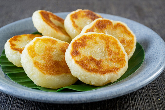 Wingko Babat, authentic Javanese sweet snack made of glutinous rice flour and grated coconut. served on a plate lined with a green banana leaf