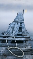 Fototapeta premium Serene watercolor seascape pier evokes quiet contemplation on a misty aged wooden shoreline