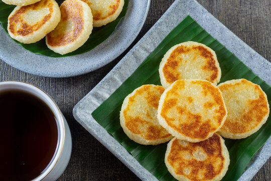 Wingko Babat, authentic Javanese sweet snack made of glutinous rice flour and grated coconut. served on a plate lined with a green banana leaf