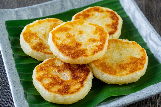 Wingko Babat, authentic Javanese sweet snack made of glutinous rice flour and grated coconut. served on a plate lined with a green banana leaf
