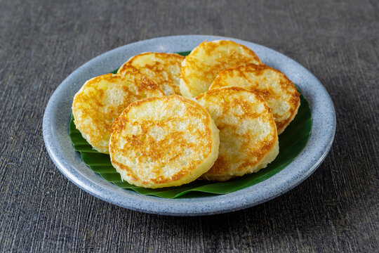 Wingko Babat, authentic Javanese sweet snack made of glutinous rice flour and grated coconut. served on a plate lined with a green banana leaf