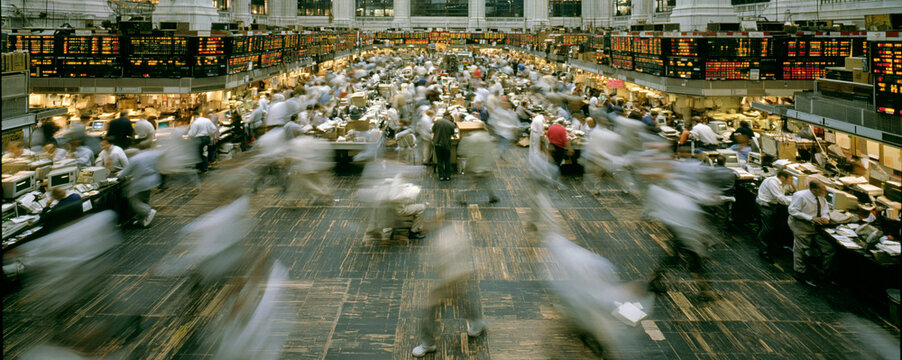 A documentary-style photograph of a commodity exchange floor, with traders actively engaging in buying and selling. The focus is on the integration of commodities into diversified portfolios,