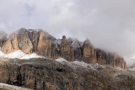 The Sass Pordoi - Pordoi Pass - in the Sella group of the Dolomites rises from the mist, South Tyrol, Italy