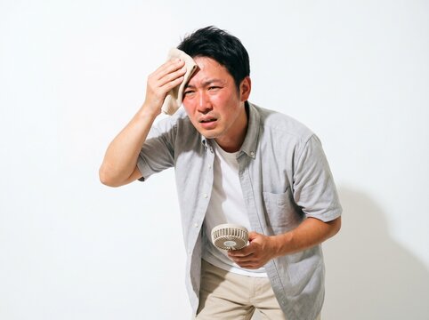 Sweating Japanese Man Wiping Forehead