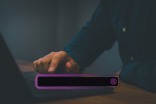 Man using laptop with virtual search bar. Internet browsing, web searching, online data finding, SEO optimization and technology business concept.