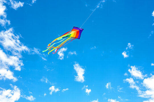 Colorful kite flying in a bright blue sky