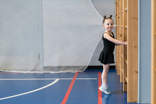 Cute little girl in a leotard at the gym